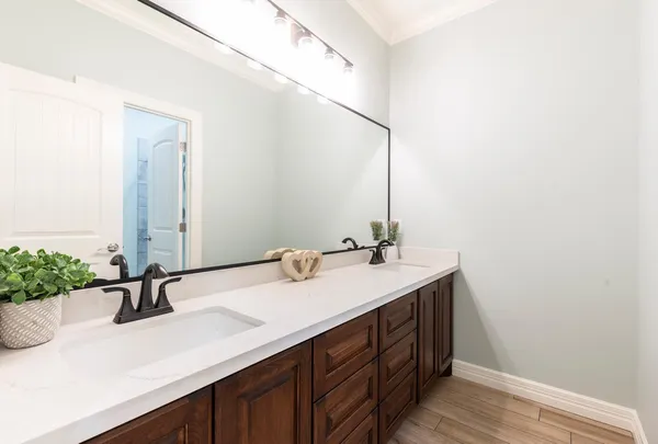 a bathroom with a double vanity sink and a mirror