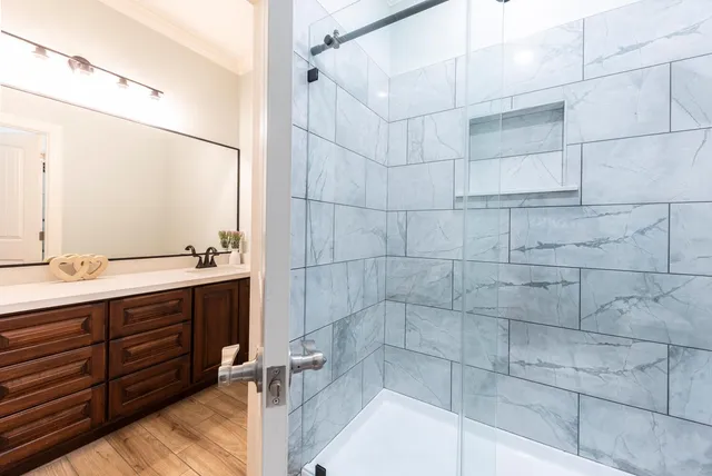 a bathroom with a double vanity sink a toilet and a mirror