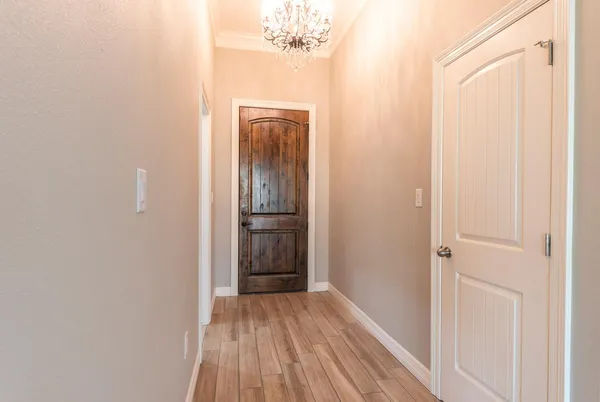 a view of a hallway with wooden floor