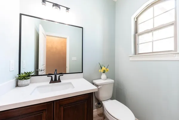 a bathroom with a sink a toilet and mirror