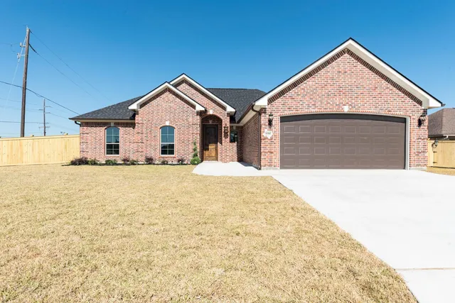 a view of a house with a yard and garage