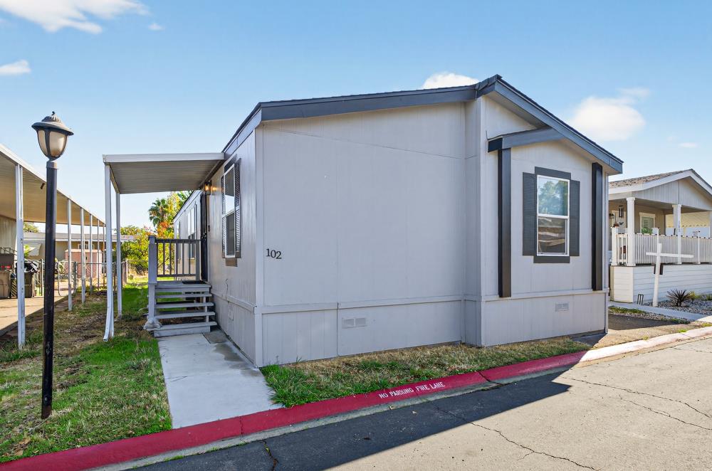 102 Village Circle Sacramento, CA 95838 - Photo 1 of 32 a yellow and red house with a outdoor space