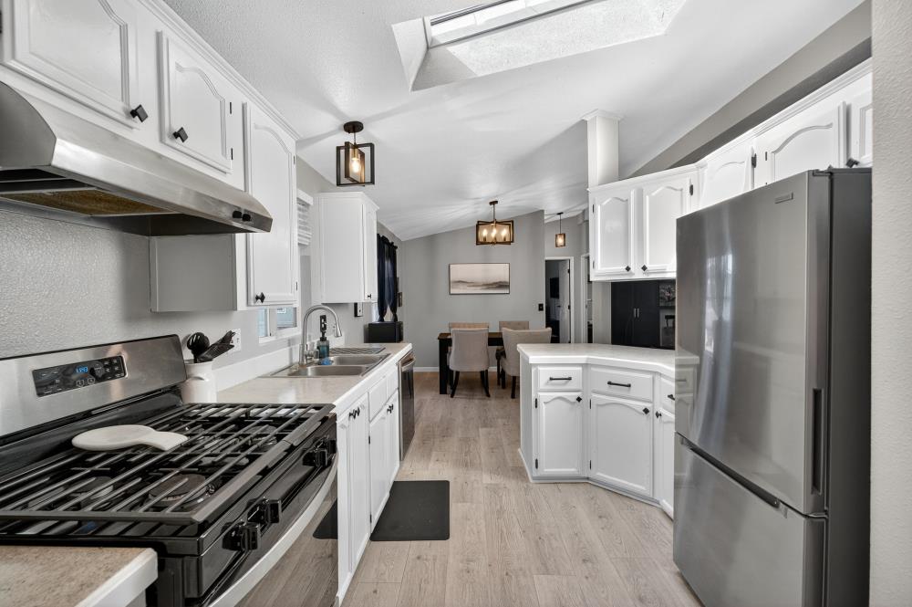 102 Village Circle Sacramento, CA 95838 - Photo 11 of 32 a kitchen with cabinets and a stove top oven