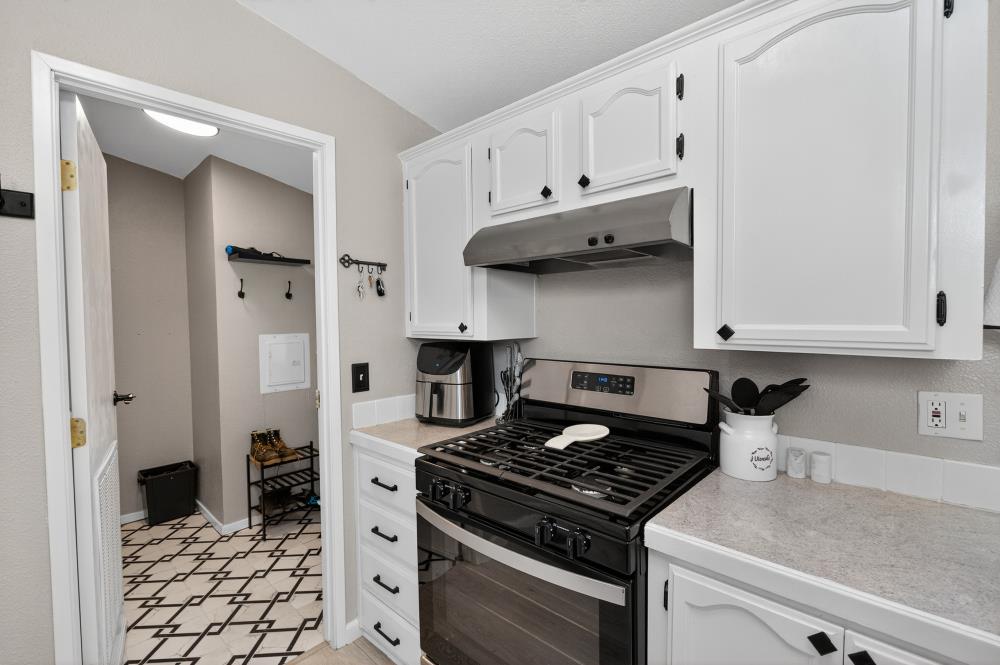 102 Village Circle Sacramento, CA 95838 - Photo 12 of 32 a kitchen with stainless steel appliances granite countertop a stove and a refrigerator