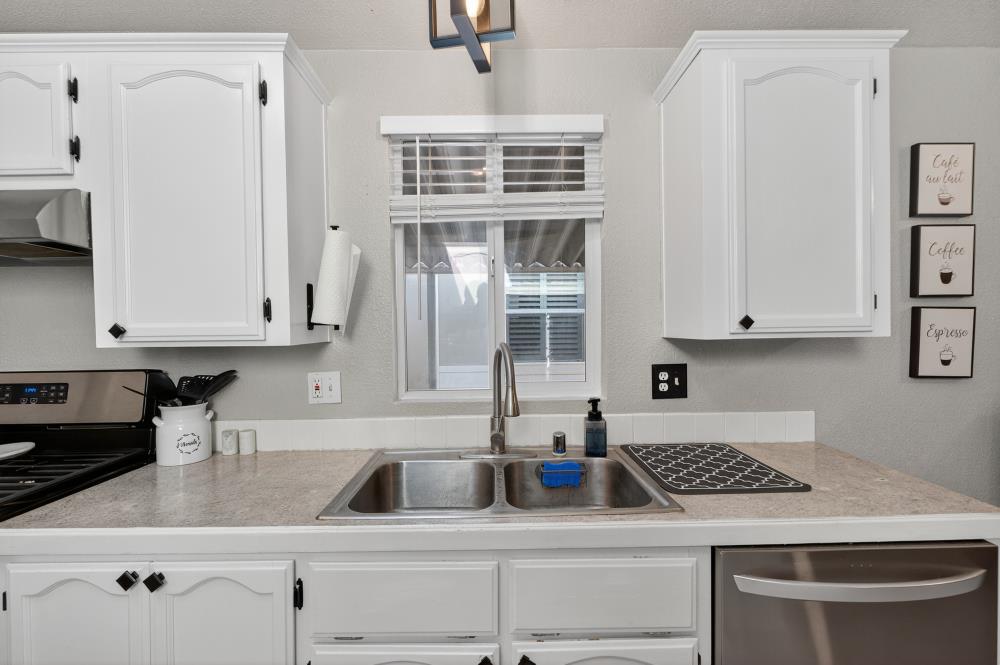 102 Village Circle Sacramento, CA 95838 - Photo 14 of 32 a kitchen with granite countertop a sink stainless steel appliances and cabinets
