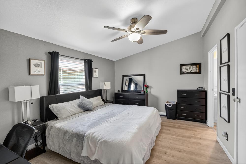 102 Village Circle Sacramento, CA 95838 - Photo 16 of 32 a bedroom with a bed and wooden floor