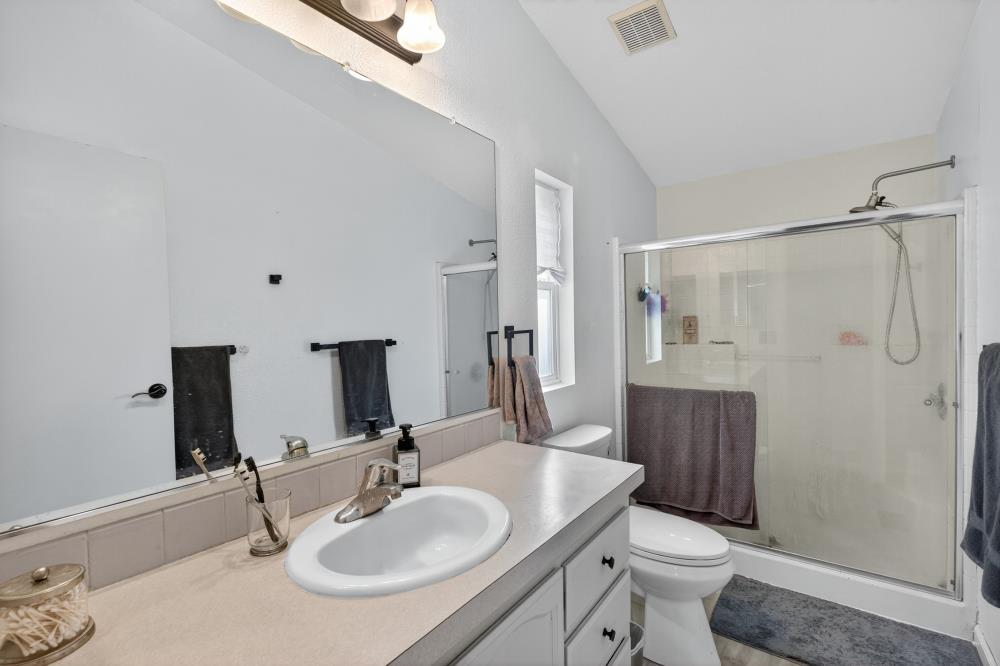 102 Village Circle Sacramento, CA 95838 - Photo 18 of 32 a bathroom with a sink toilet a mirror and shower