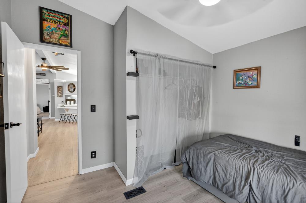 102 Village Circle Sacramento, CA 95838 - Photo 21 of 32 a bedroom with a bed and a painting on the wall