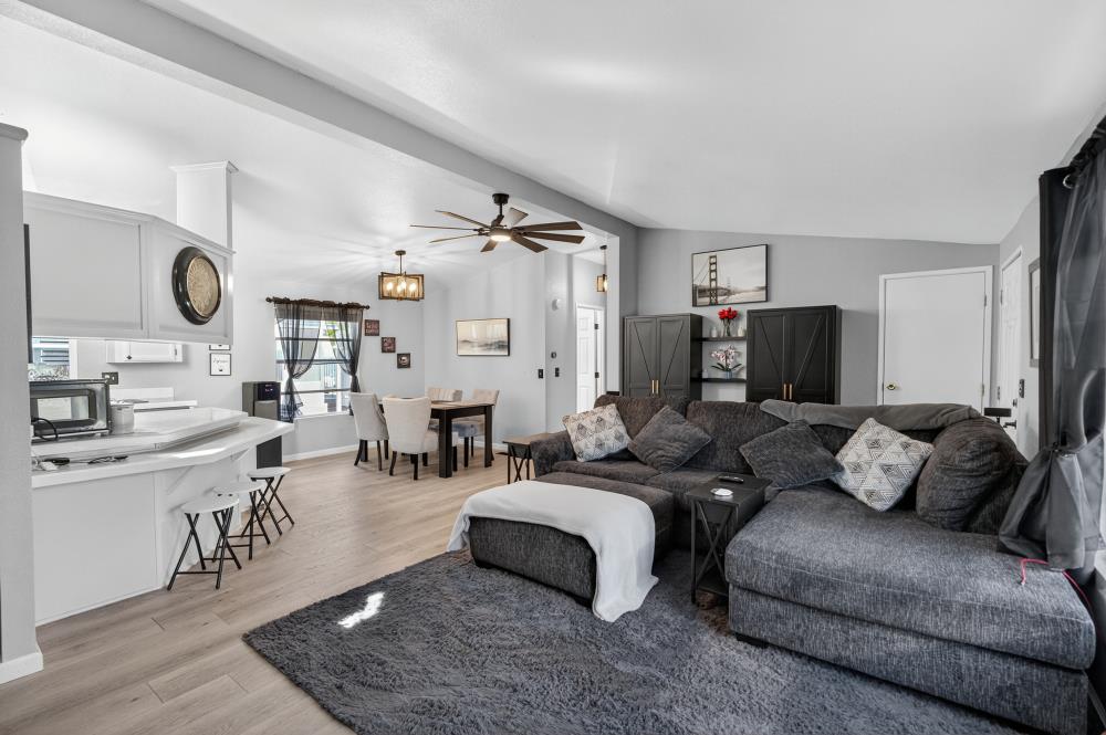 102 Village Circle Sacramento, CA 95838 - Photo 6 of 32 a living room with furniture kitchen view and a fireplace