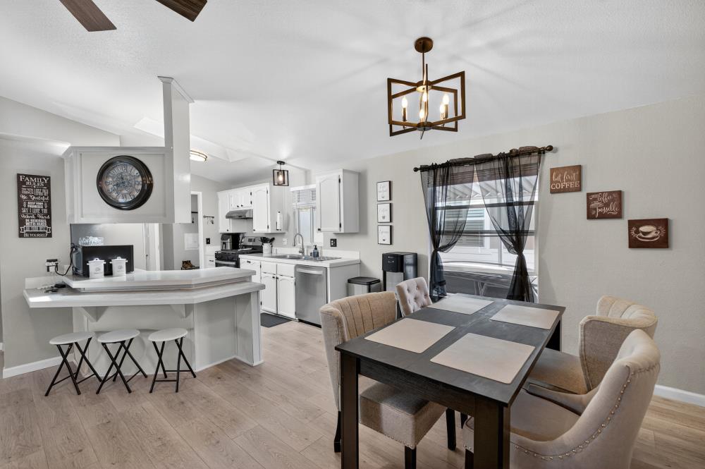 102 Village Circle Sacramento, CA 95838 - Photo 8 of 32 a living room with a table chairs and a clock