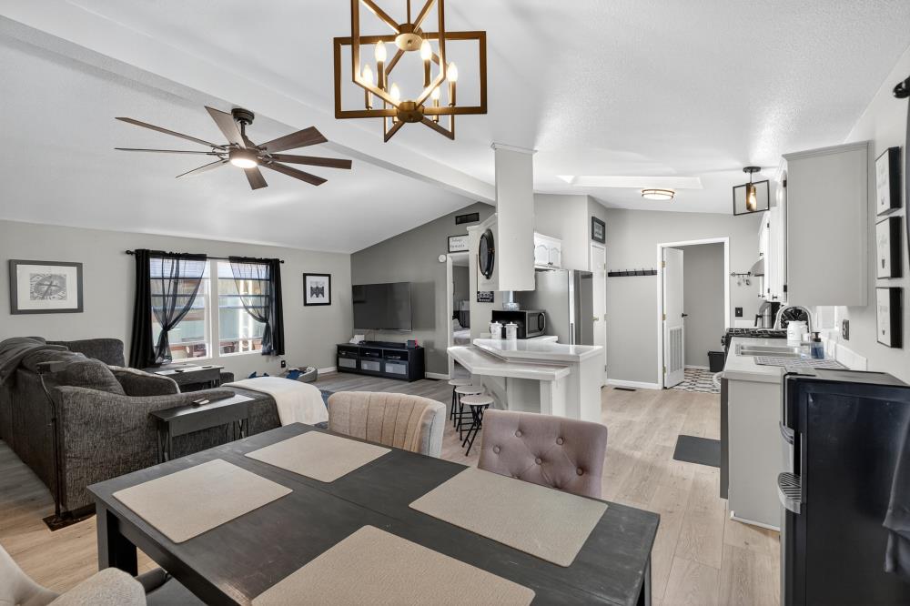 102 Village Circle Sacramento, CA 95838 - Photo 9 of 32 a living room with furniture a flat screen tv and kitchen view