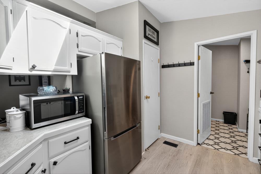 102 Village Circle Sacramento, CA 95838 - Photo 10 of 32 a kitchen with stainless steel appliances a refrigerator and a stove top oven