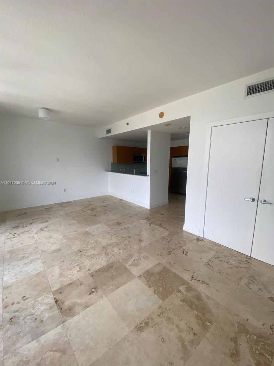 1060 Brickell Avenue, Unit 3309 Miami, FL 33131 - Photo 18 of 25 a view of a big room with closet and wooden floor
