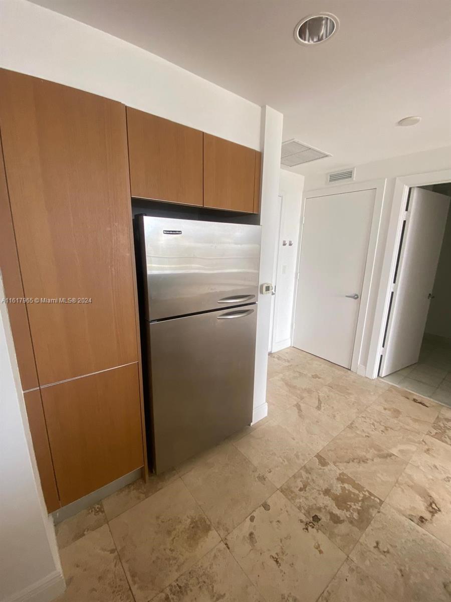 1060 Brickell Avenue, Unit 3309 Miami, FL 33131 - Photo 7 of 25 a view of empty room with refrigerator and microwave