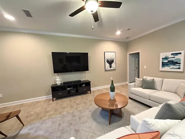 a living room with furniture and a flat screen tv