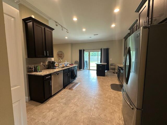 4716 Chanson Crossing Crestview, FL 32539 - Photo 5 of 16 a kitchen with a refrigerator and a sink