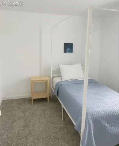 a bedroom with a bed and a wall painting