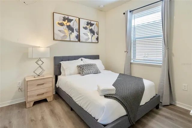 a bedroom with a bed and a window