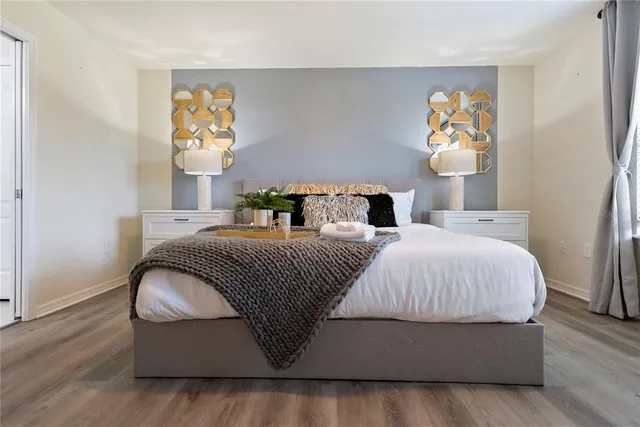 a bathroom with a granite countertop double vanity and a mirror