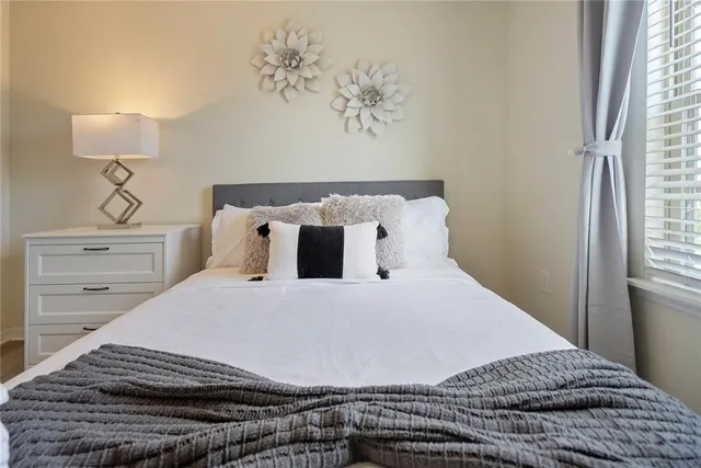 a view of a dining room with furniture a rug and wooden floor