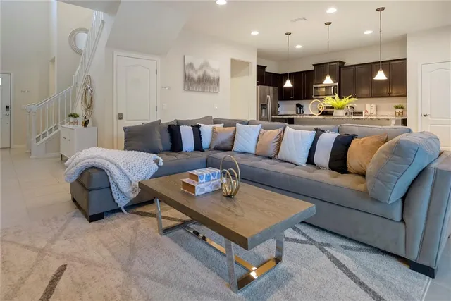 a living room with furniture and kitchen view