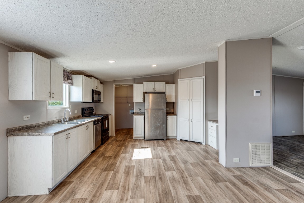 346 Rancho Linda Drive Lockhart, TX 78644 - Photo 10 of 25 a kitchen with stainless steel appliances granite countertop a refrigerator and a stove top oven