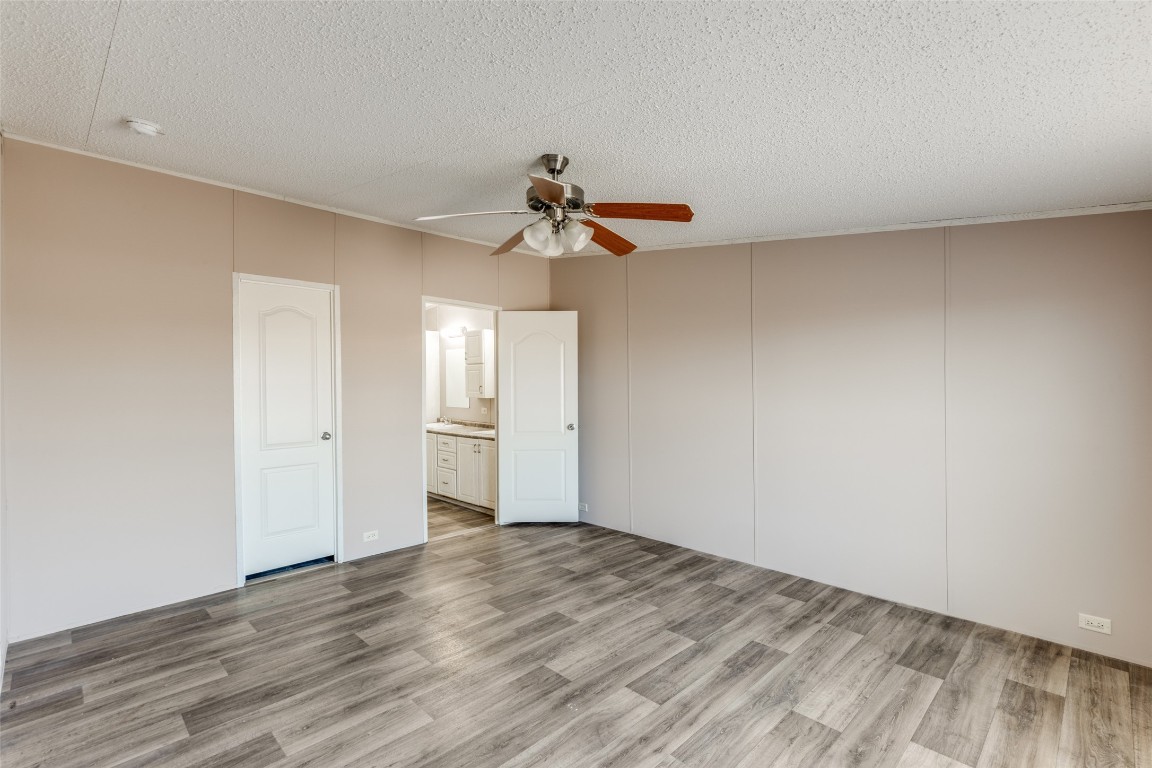346 Rancho Linda Drive Lockhart, TX 78644 - Photo 15 of 25 a view of a room with a ceiling fan and wooden floor