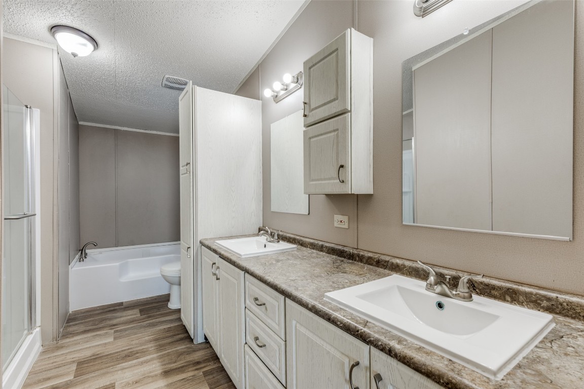 346 Rancho Linda Drive Lockhart, TX 78644 - Photo 17 of 25 a bathroom with a sink double vanity granite tub and shower