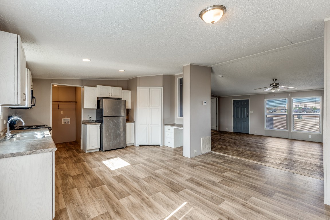 346 Rancho Linda Drive Lockhart, TX 78644 - Photo 25 of 25 a view of a kitchen with refrigerator stove and wooden floor