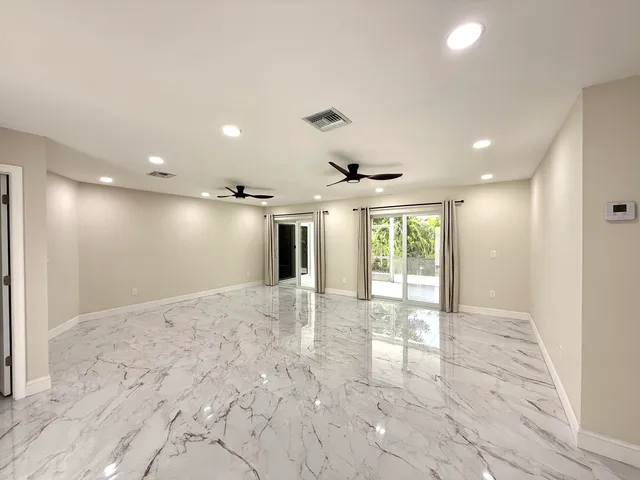 a bathroom with a granite countertop sink a mirror and shower