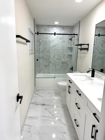 a bathroom with double sink and a mirror