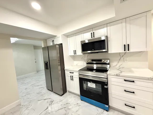 a kitchen with a stove microwave and refrigerator