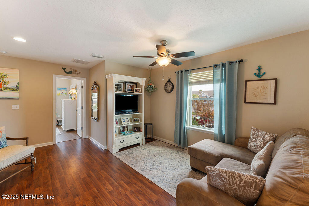 205 Islander Drive St. Augustine, FL 32080 - Photo 17 of 43 a living room with furniture flat screen tv and wooden floor