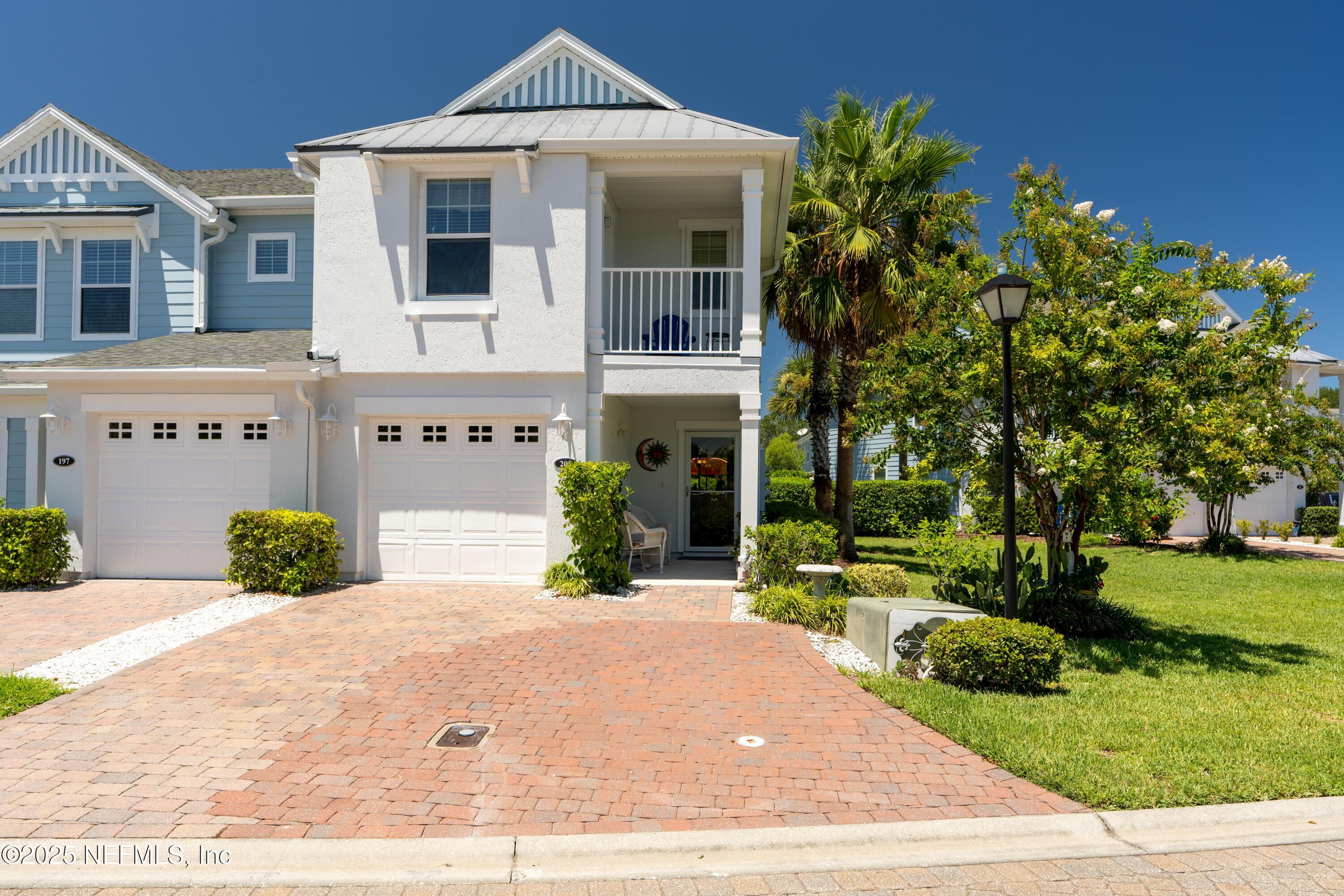 205 Islander Drive St. Augustine, FL 32080 - Photo 2 of 43 a front view of a building with garden