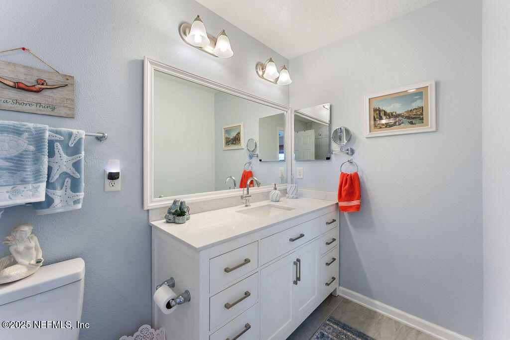 205 Islander Drive St. Augustine, FL 32080 - Photo 21 of 43 a bathroom with a sink vanity and mirror