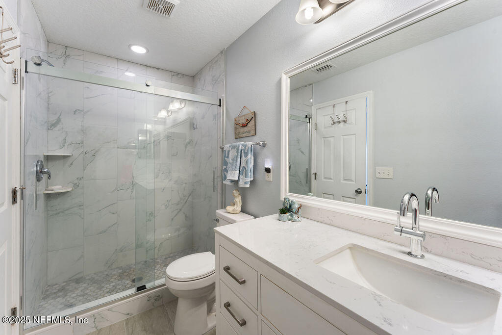 205 Islander Drive St. Augustine, FL 32080 - Photo 22 of 43 a bathroom with a sink toilet and shower