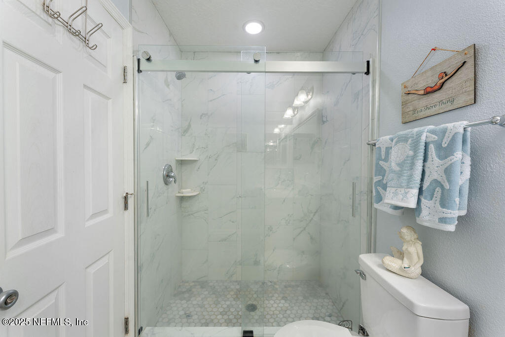 205 Islander Drive St. Augustine, FL 32080 - Photo 23 of 43 a bathroom with a shower and toilet