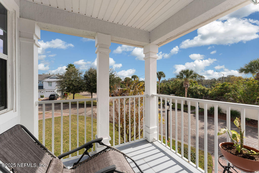 205 Islander Drive St. Augustine, FL 32080 - Photo 27 of 43 a view of a balcony with floor to ceiling windows with wooden floor