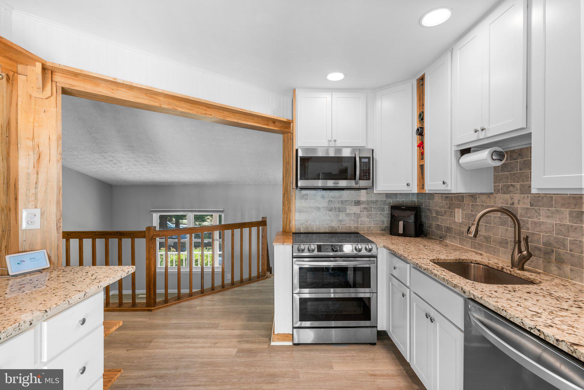 8630 Bali Road Ellicott City, MD 21043 - Photo 7 of 32 Kitchen w/ SS Appliances & Granite Countertops