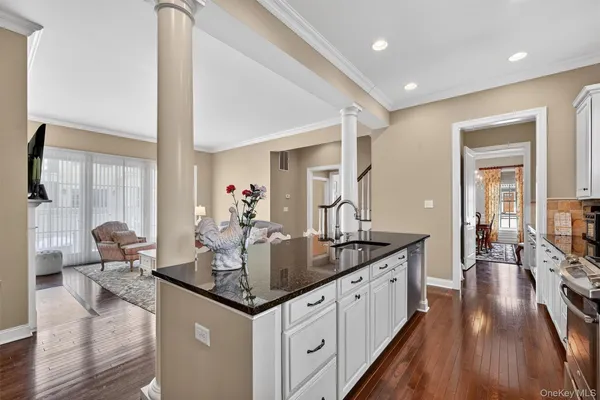 a view of living room with granite countertop furniture and wooden floor