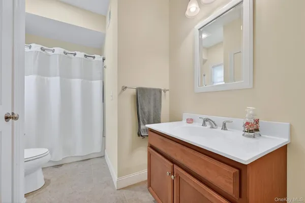 a bathroom with a sink vanity and a mirror