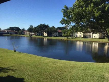 a view of a lake with houses in the background