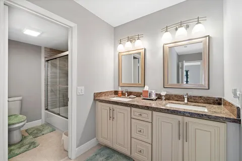 a bathroom with 2 sink and a mirror