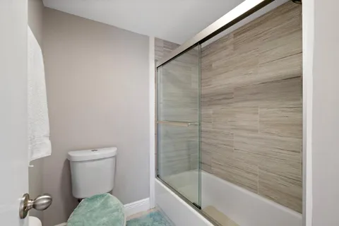 a bathroom with a toilet and a shower