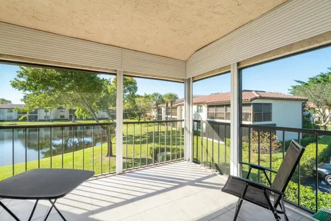 a view of a balcony with wooden floor and lake view