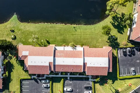 an aerial view of a houses with swimming pool