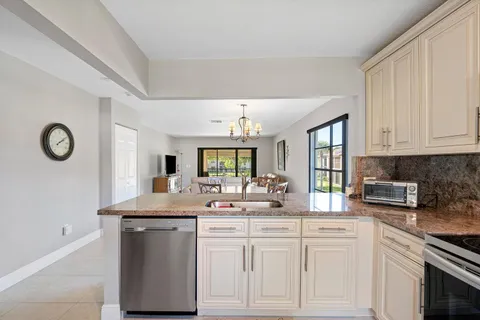 a kitchen with sink and cabinets