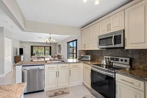 a kitchen with stainless steel appliances granite countertop a sink and cabinets
