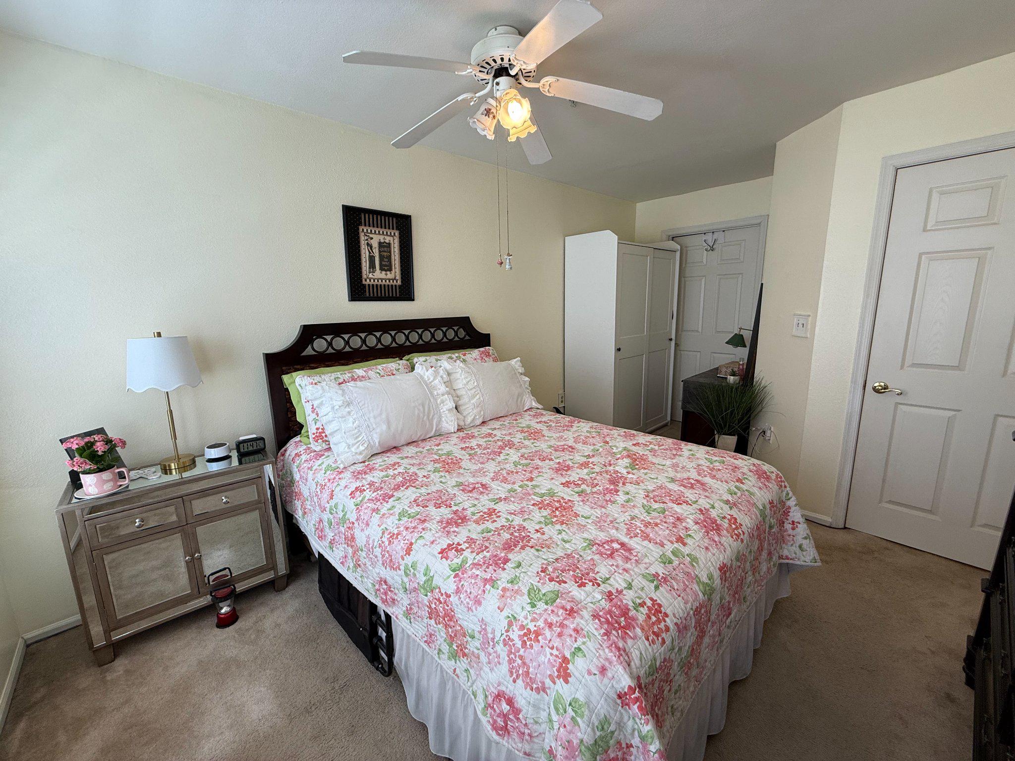 302 Canterbury Road, Unit 302E Bel Air, MD 21014 - Photo 17 of 39 a bedroom with a bed and a chandelier