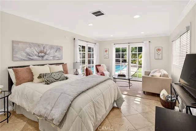 a bedroom with a bed and glass windows